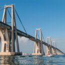 Which major South American city remained completely isolated by road for most of its history until the construction of a bridge in the mid-20th century?